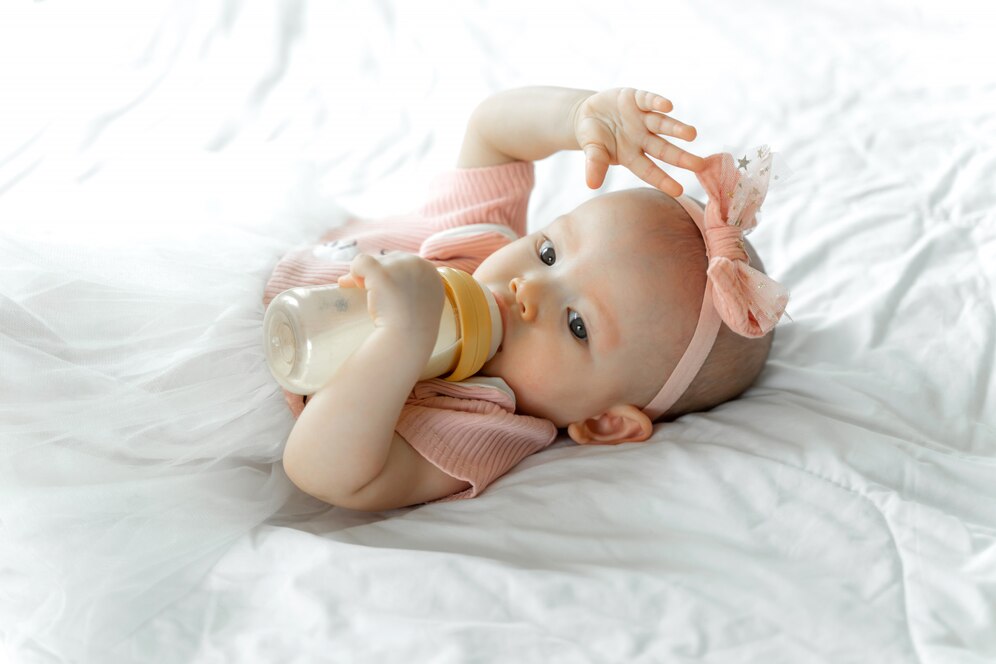 Baby Drinks Milk From Bottle White Bed 1150 18365